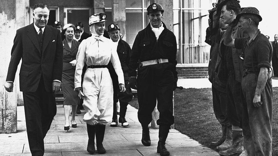 The Queen wearing miner's overalls is accompanied by workers before descending the mine at Rothes Colliery in Fife during a visit to the area