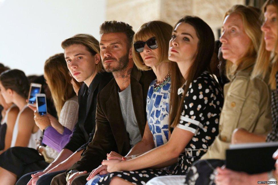 Brooklyn and David watch Victoria's runway show with Vogue editor-in-chief Anna Wintour