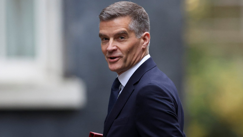 Secretary of State for Transport Mark Harper walks at Downing Street