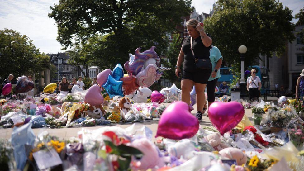 Flowers and tributes have been left outside the scene