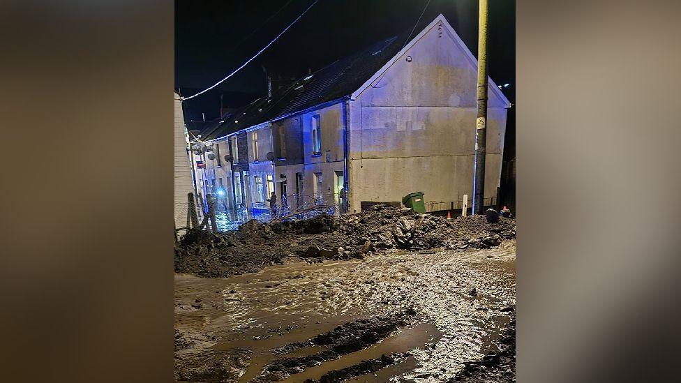 A picture showing mud strewn across a street