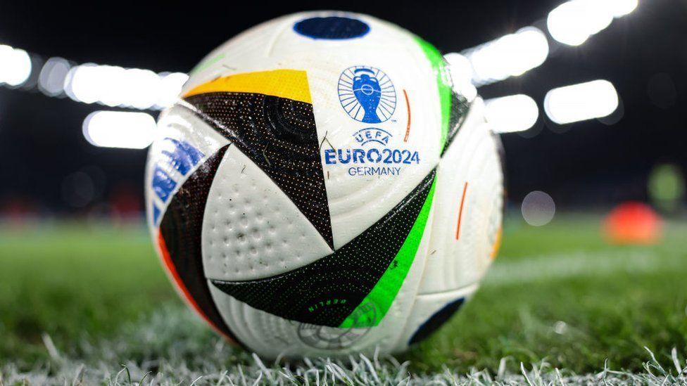 Football with white, black, green and yellow triangles with the UEFA logo which says UEFA EURO 2024 GERMANY