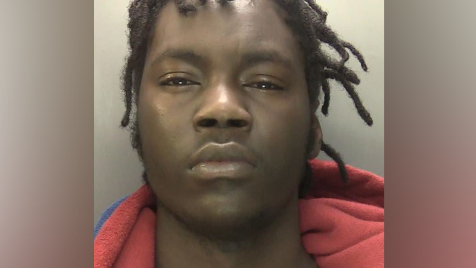 Police mugshot of Meshaq Berryman, wearing a blue and red fleece jacket