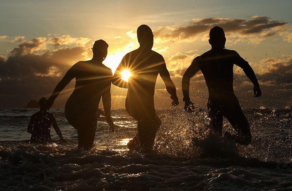 Competitors enter the water for the swim leg during the start of the 2025 IRONMAN Cairns in Australia. Photo by Cameron Spencer