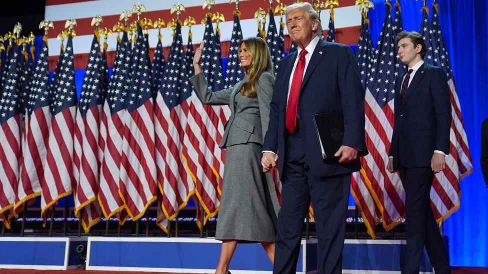 Republican presidential nominee former President Donald Trump, Melania Trump and Barron Trump, arrive to speaks at an election night watch party, Wednesday, Nov. 6, 2024, in West Palm Beach, Fla.