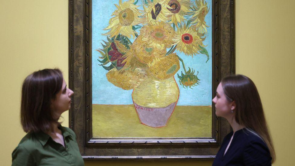 Gallery workers view Dutch artist Vincent van Gogh's work titled 'Sunflowers' (1889) during a preview for the exhibition 'Van Gogh: Poets and Lovers' at the National Gallery in London, Britain, 09 September 2024