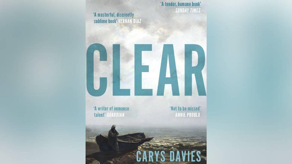 A foreboding cloudy sky hangs over the shore on the island on the cover of Clear, with a lone silhouetted figure standing perched against a wooden boat, looking like he is waiting. The book cover has reviews including 'not to be missed' by Annie Proulx and 'a writer of immense talent' by The Guardian.