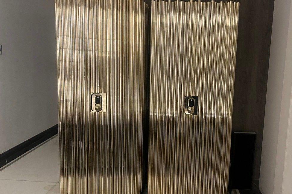 two full-length safes, golden in colour