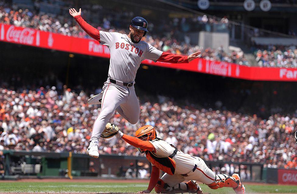 Boston Red Sox's Abraham Toro is out at home plate after leaping over catcher San Francisco Giants' Patrick Bailey in the top of the fourth inning. Photo by Thearon W. Henderson