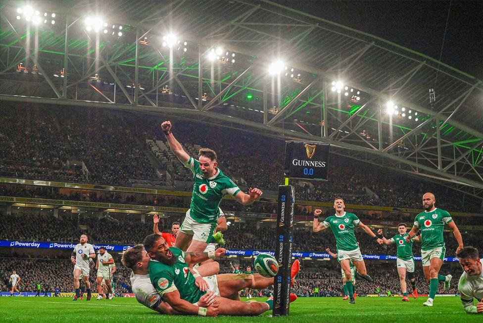 A grounded Bundee Aki celebrates after scoring Ireland's second try during the Six Nations match against England at Aviva Stadium in Dublin