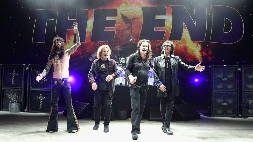 Black Sabbath on stage in 2016 in front of the giant words "The End"