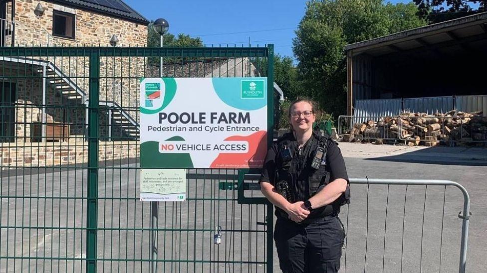 PC Sarah Hill standing beside the entrance to Poole Farm