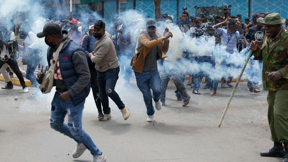 Protesters run from tear gas in Nairobi, Kenya - 18 June 2024