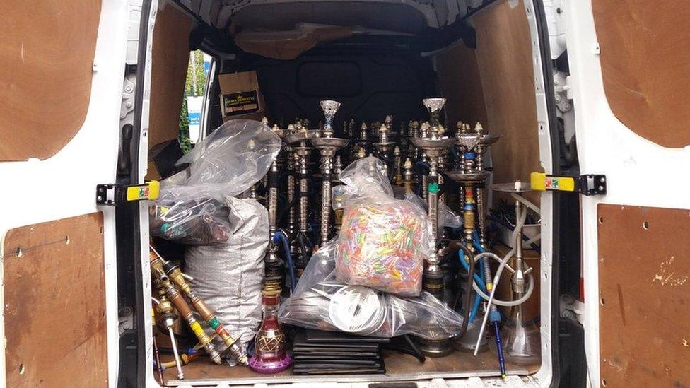 Seized shisha pipes being taken away by the council