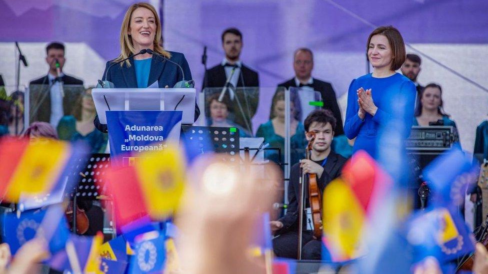 European Parliament President Roberta Metsola (C) address to the people as Moldova's President Maia Sandu (C,R) listens on, during a pro-EU rally in Chisinau on May 21, 2023. Met