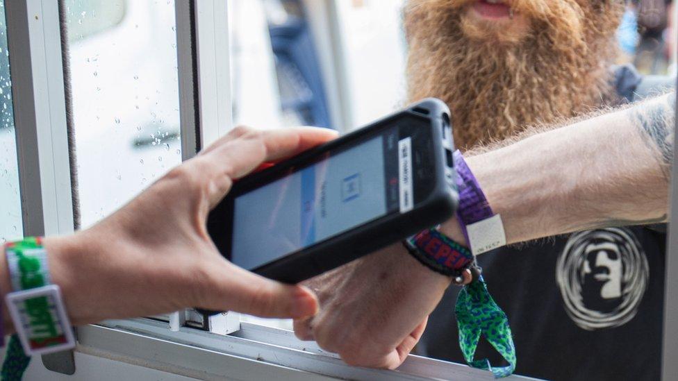 Festival attendee uses a wristband to pay at 2000Trees