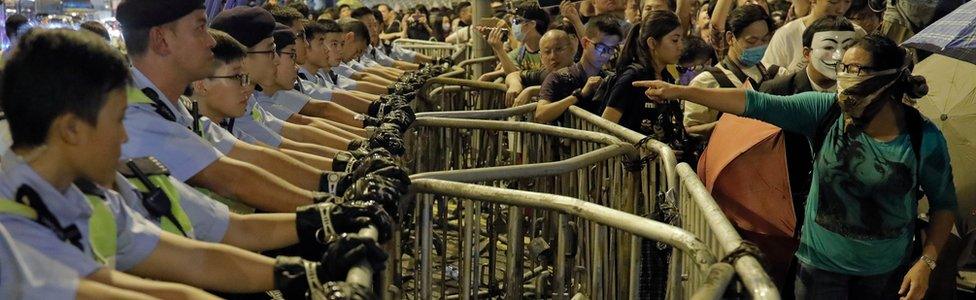 Protesters shout to police officers during protest in Hong Kong