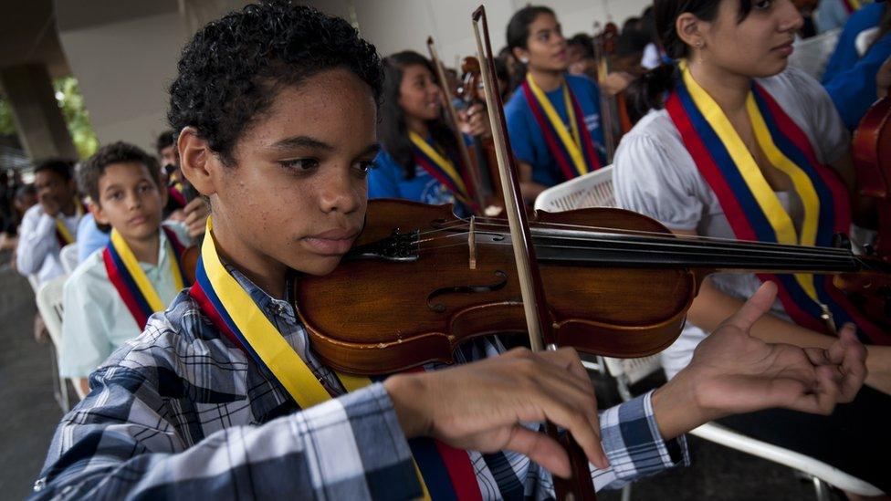 A Venezuelan young musician of 'El Sistema' plays during a free concert at Teresa Carreno theatre in Caracas February 16, 2012