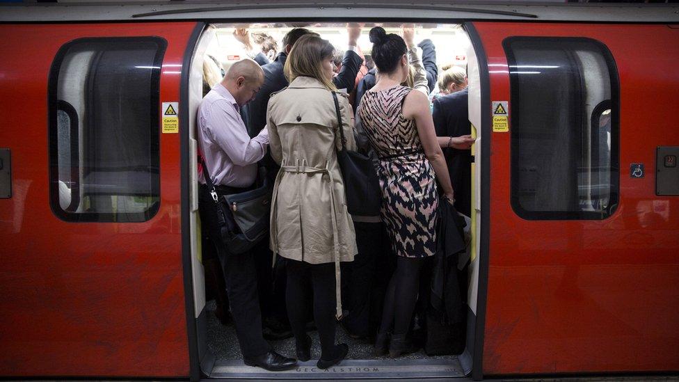 Commuters squeeze into a crowded Tube carriage