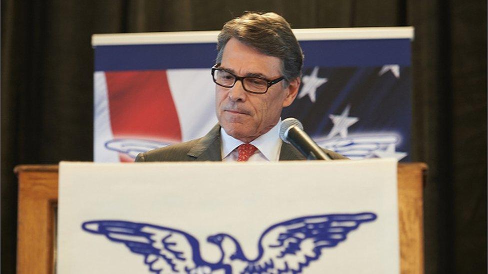 Former governor Rick Perry at a podium in St Louis announcing he is dropping out of the presidential race