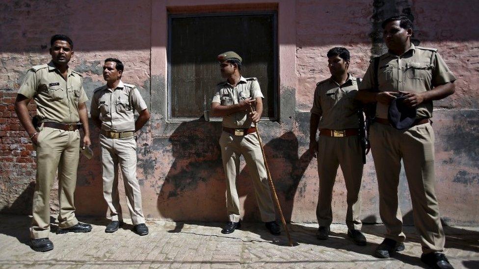 Indian policemen stand guard near the house of Akhalaq Saifi, who was killed by a mob, at Bisara village in Uttar Pradesh, India, October 2, 2015.