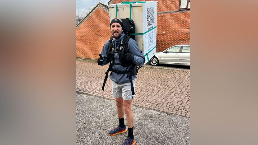 man carrying fridge 