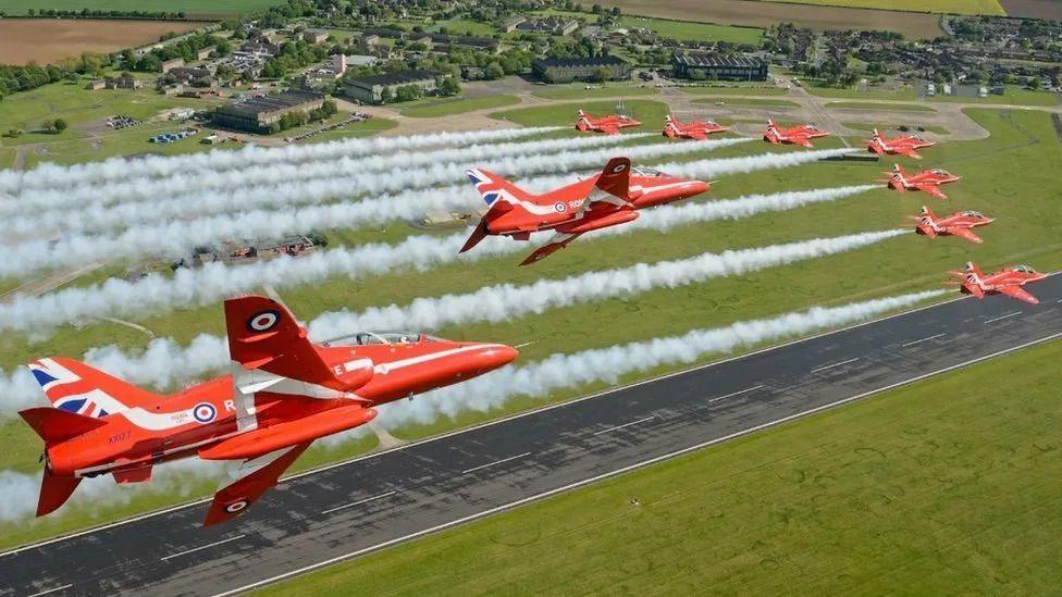 The Red Arrows flying in formation over the RAF Scampton site. 