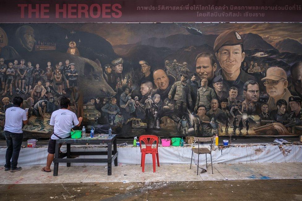 Artists work on an art mural at Art Bridge gallery in Chiang Rai, Thailand