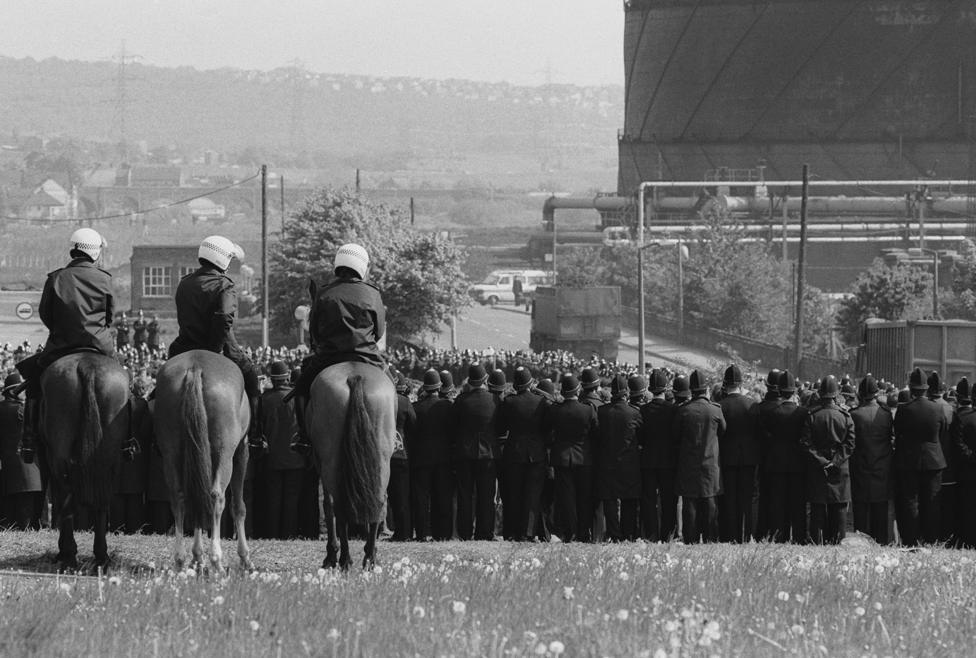 Police on horses behind the front line, looking down on miners