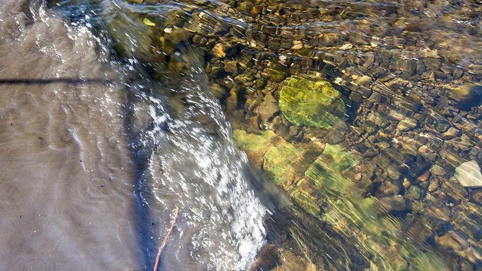 Raw sewage mixing with clean clear water