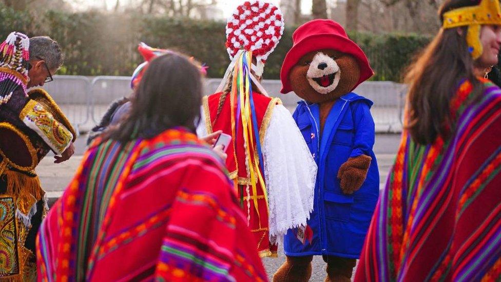 A performer in a Paddington Bear costume waiting on Piccadilly for the start of the New Year's Day Parade in London