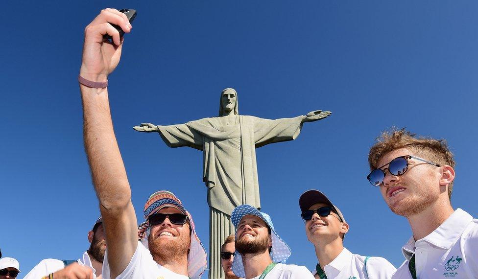 Jake Whetton of the Australian Men's Hockey team takes a photo of himself and team mates in front of the Christ the Redeemer statue on August 1, 2016 in Rio de Janeiro, Brazil.