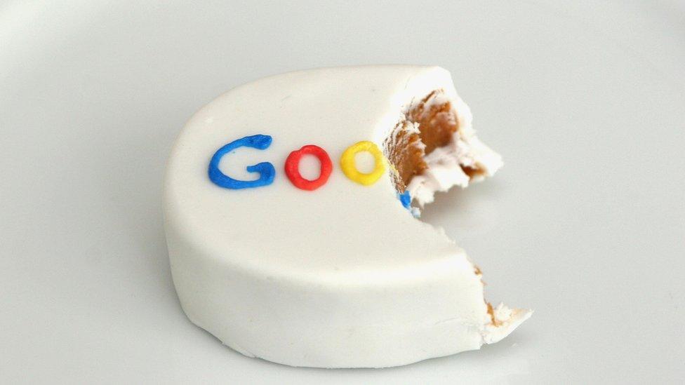 A small hand-sized cake with a bite taken out of it - and the Google logo in icing on top - is seen in this photo