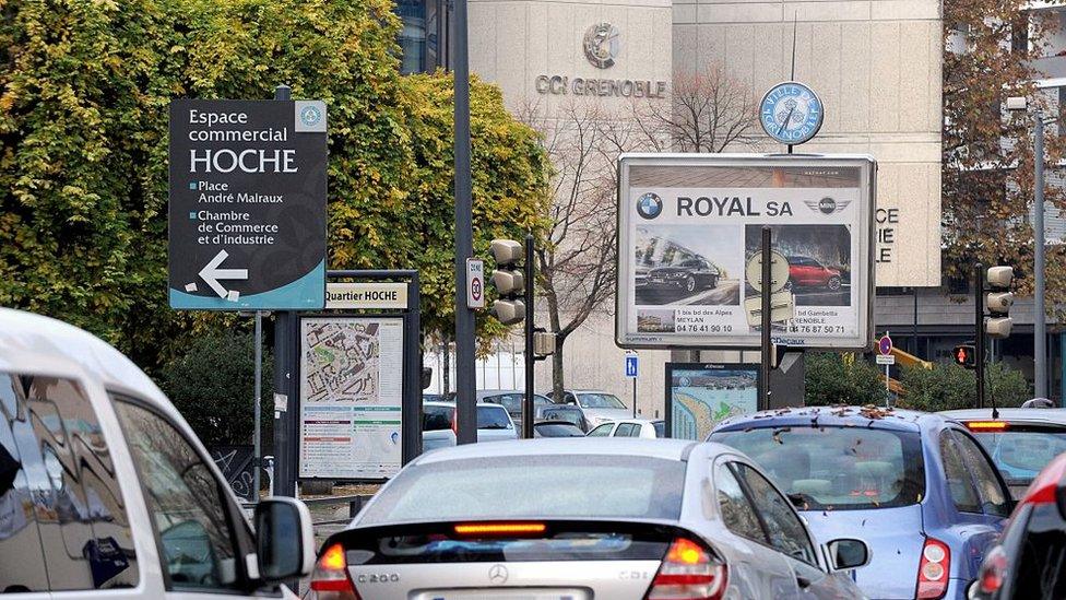 Car driving past adverts in the French city of Grenoble