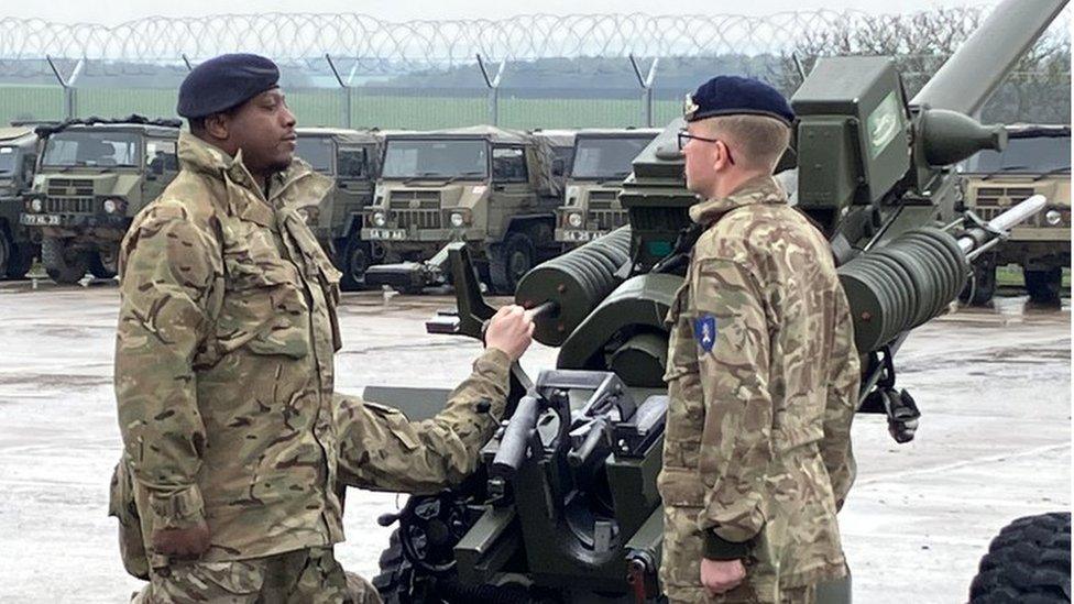 Troops rehearsing firing a gun