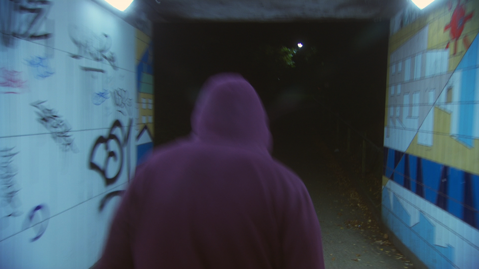 Teenager walking through subway