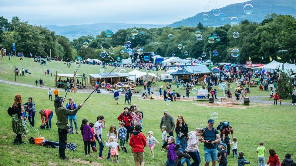 Attendees blow bubbles and play at the festival