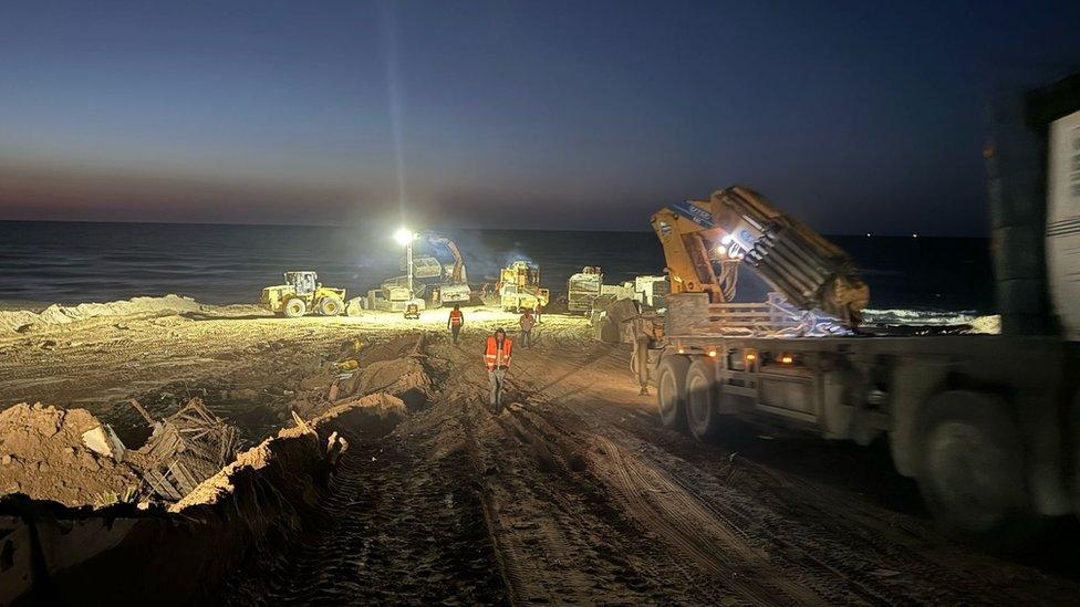 Photo posted on social media by World Central Kitchen founder Jose Andres showing the charity's workers constructing a jetty on Gaza's Mediterranean coast