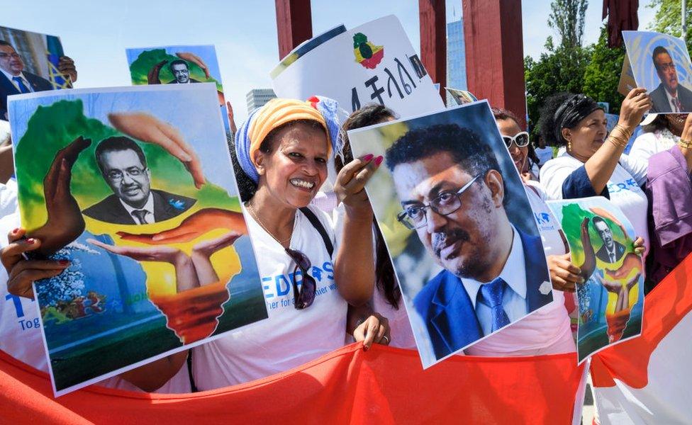 People hold placards picturing Ethiopian Candidate for the post of Director General of World Health Organization (WHO) Tedros Adhanom Ghebreyesus, during a rally on his support, in front of the United Nations offices.