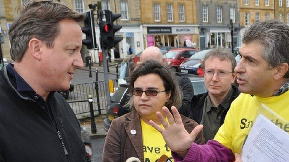 David Cameron in Chipping Norton being confronted by ACE Centre protesters