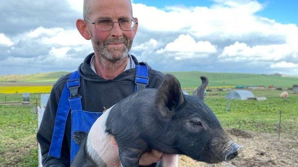 Cameron Naughton holding pig