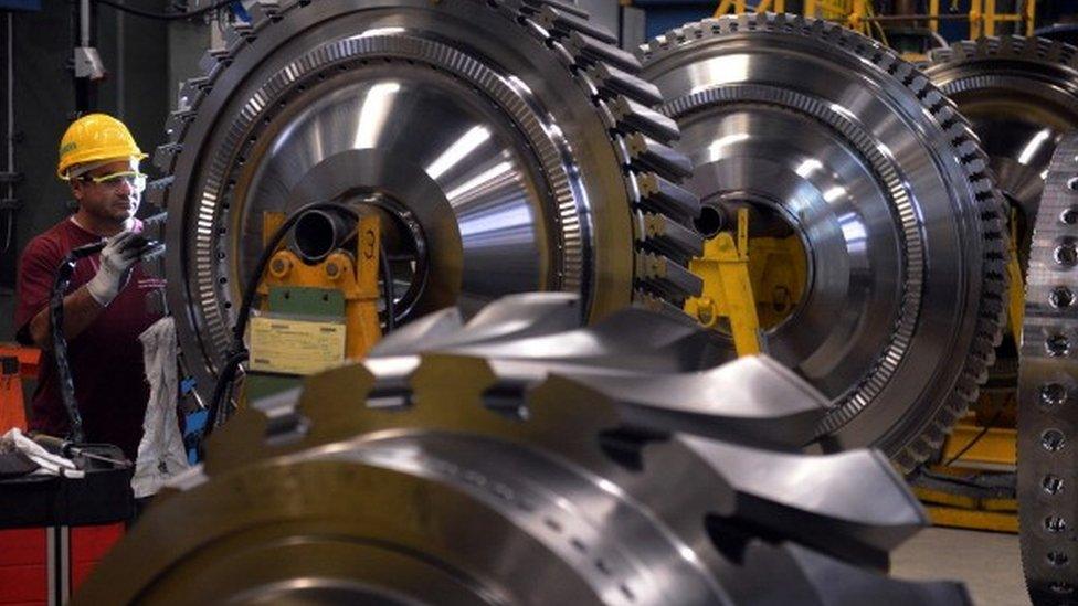 An employee of German industrial giant Siemens, works on a rotor as a part of a Gas Turbine in the turbine plant on November 8, 2012 in Berlin.