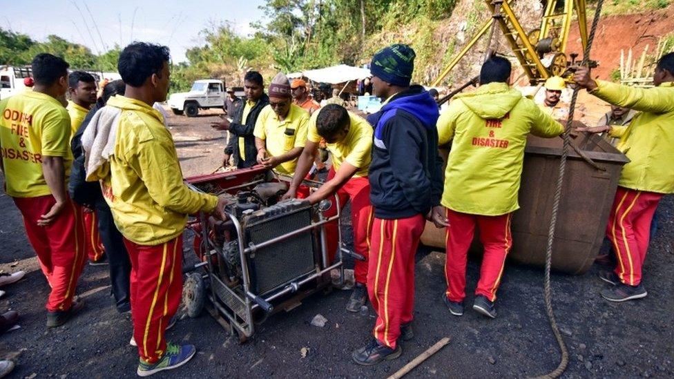 Rescuers prepare a water pump at the site of a coal mine that collapsed in Ksan