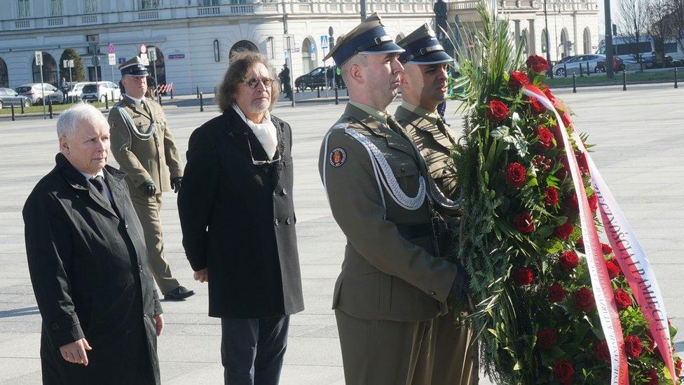 Leader of the Polish Law and Justice (PiS) ruling party Jaroslaw Kaczynski (L) lays a wreath at the monument of late President Lech Kaczynski at Pilsudski Square in Warsaw, Poland, on April 10