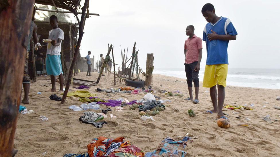 Residents look at items left on the beach on March 14 2016 in Grand Bassam,