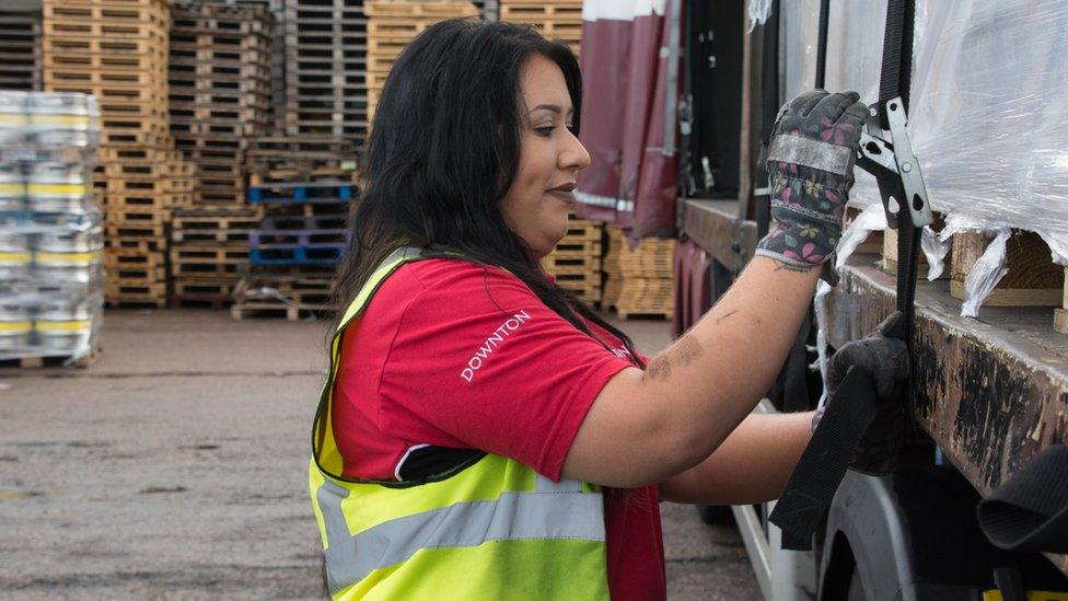 Leonie John tightening straps on a trailer