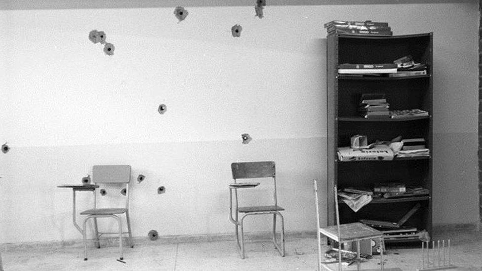 Bullet holes in classroom wall