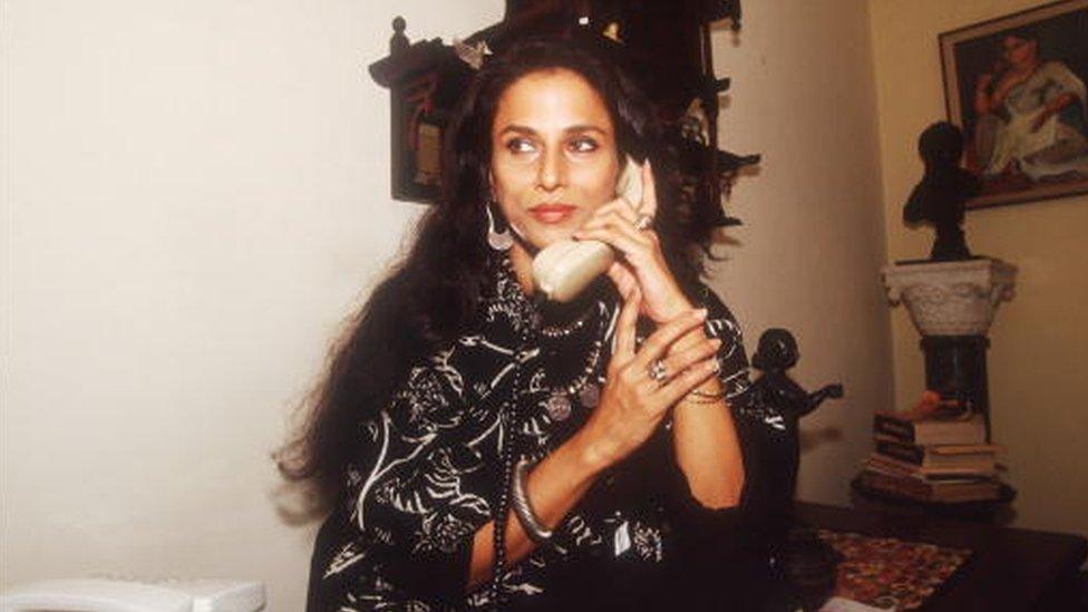 Indian author Shobha De speaks on the phone in her home February 4, 1993 in Bombay, I