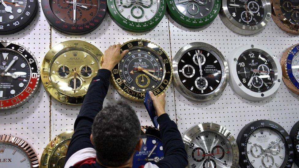 A man changes the time at a clock and watch shop in Beirut, Lebanon (27 March 2023)