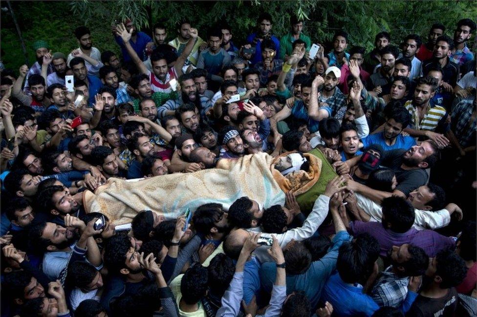 In this July 9, 2016 file photo, Kashmiri villagers carry the body of Burhan Wani, chief of operations of Indian Kashmir"s largest rebel group Hizbul Mujahideen, during his funeral procession in Tral, some 38 Kilometers (24 miles) south of Srinagar, Indian controlled Kashmir.